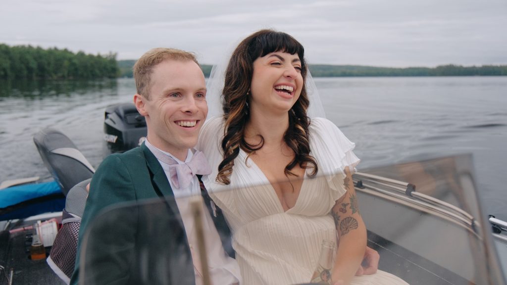 happy couple just married on a boat on the lake
